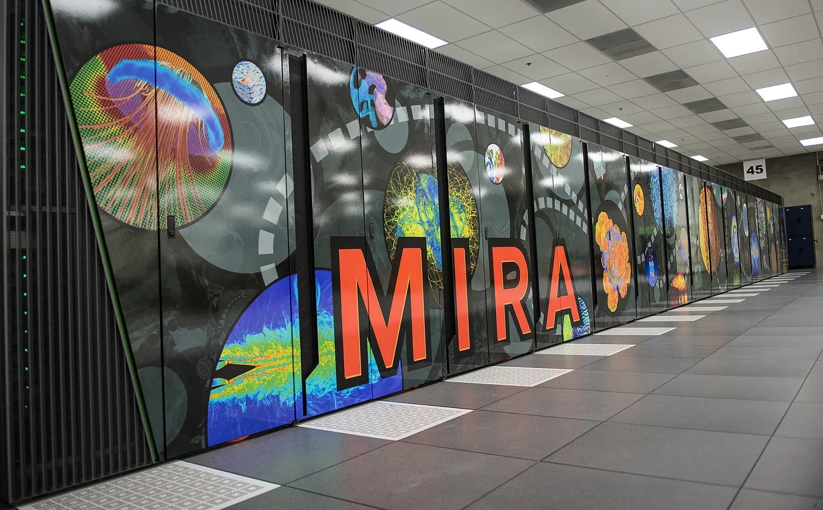 The Mira supercomputer, its row of cabinets covered in colourful science graphics